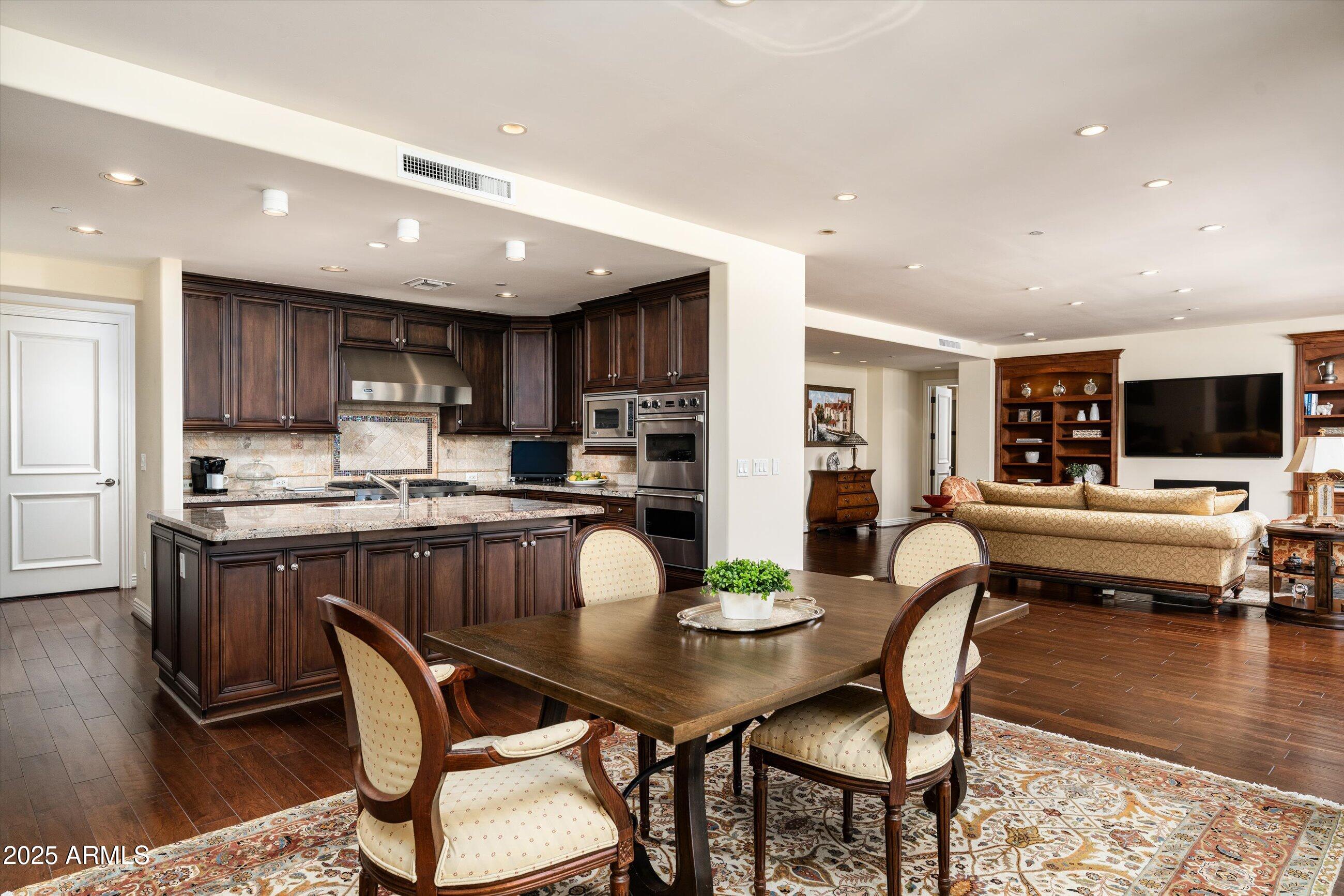 7181 East Camelback Road, Unit 1202 Scottsdale, AZ 85251 - Photo 17 of 47 a view of a dining room with furniture and wooden floor