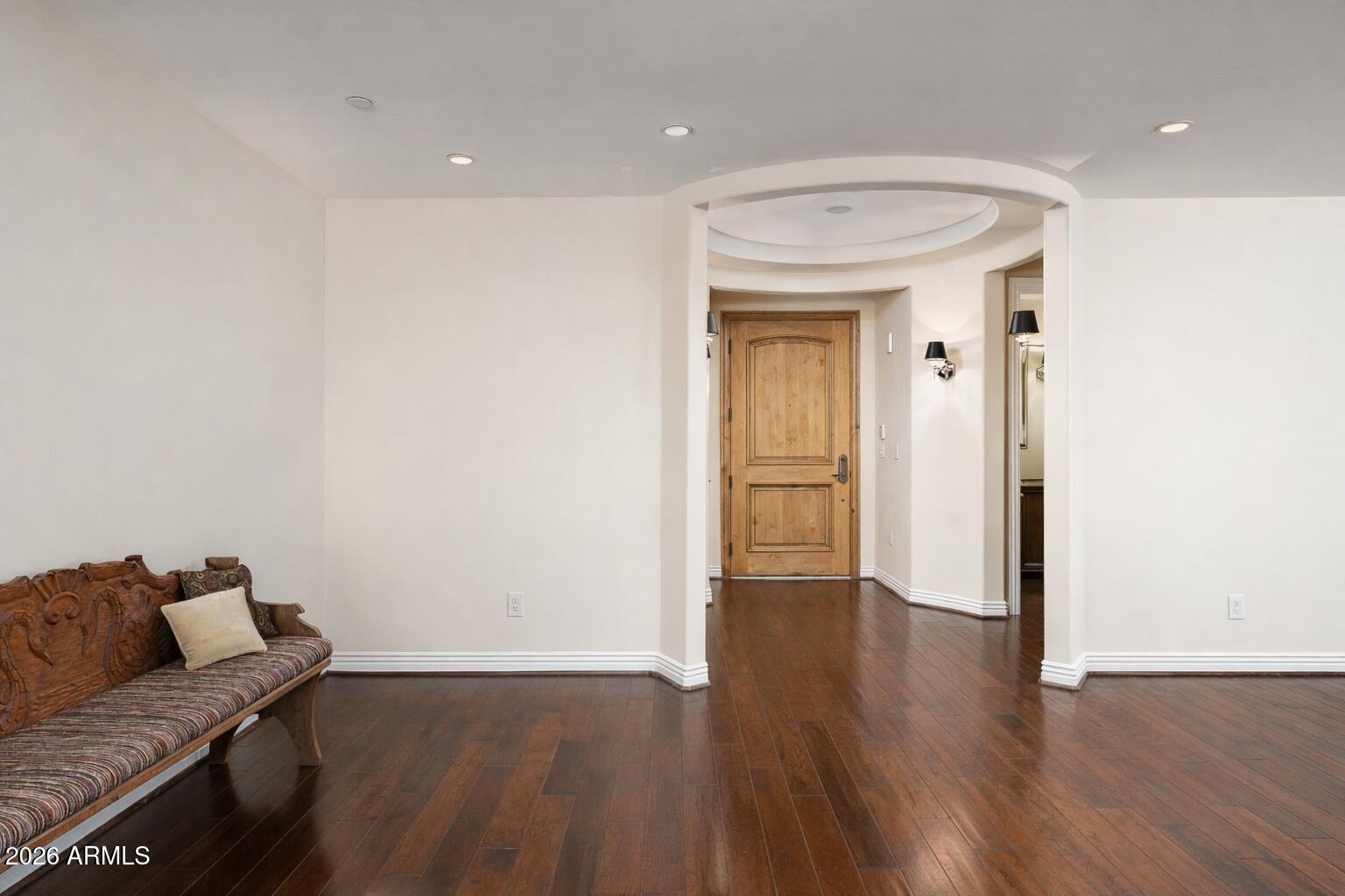 7181 East Camelback Road, Unit 1202 Scottsdale, AZ 85251 - Photo 18 of 47 a view of a livingroom with wooden floor and a couch