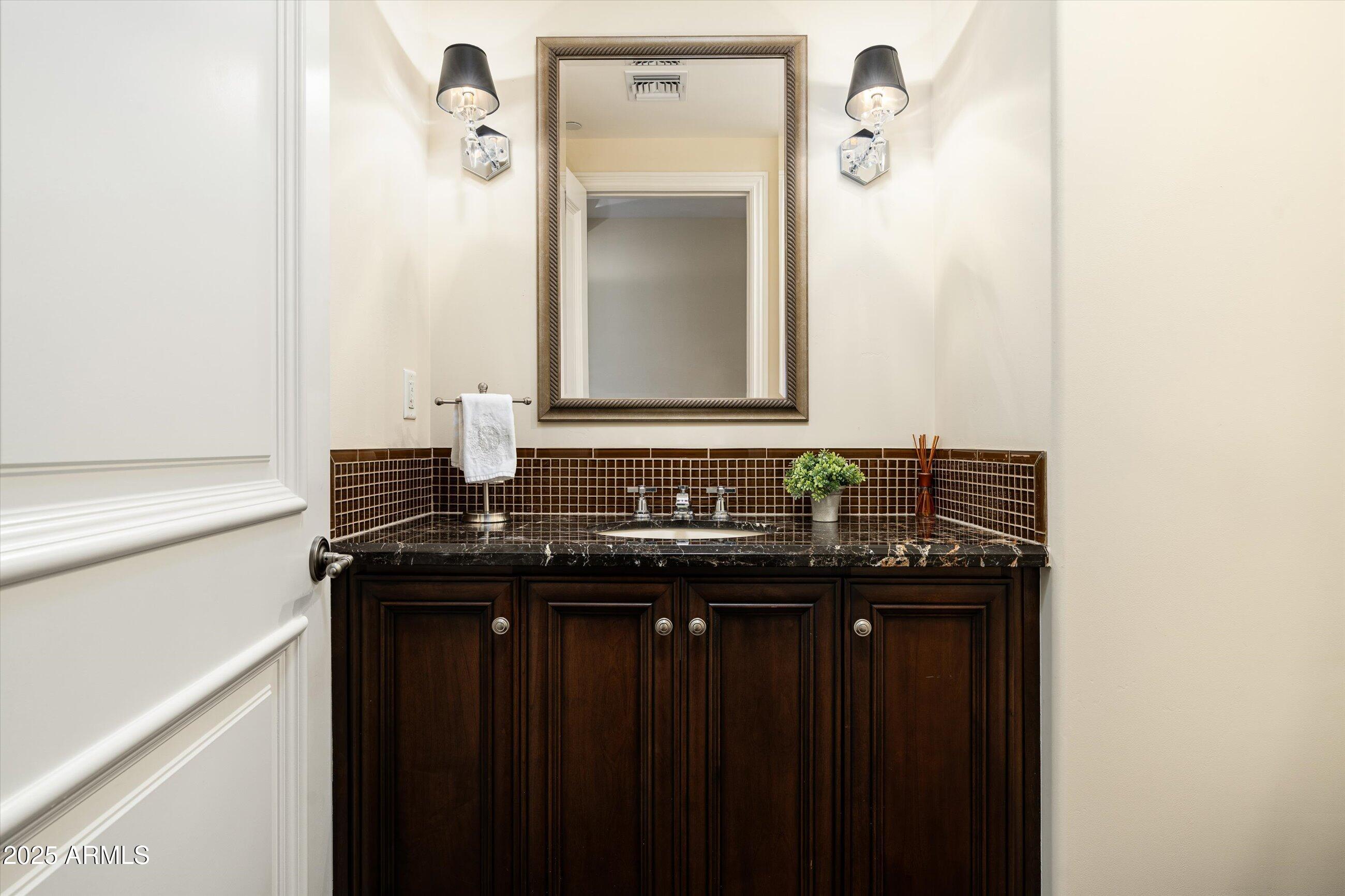 7181 East Camelback Road, Unit 1202 Scottsdale, AZ 85251 - Photo 19 of 47 a bathroom with a sink and a mirror