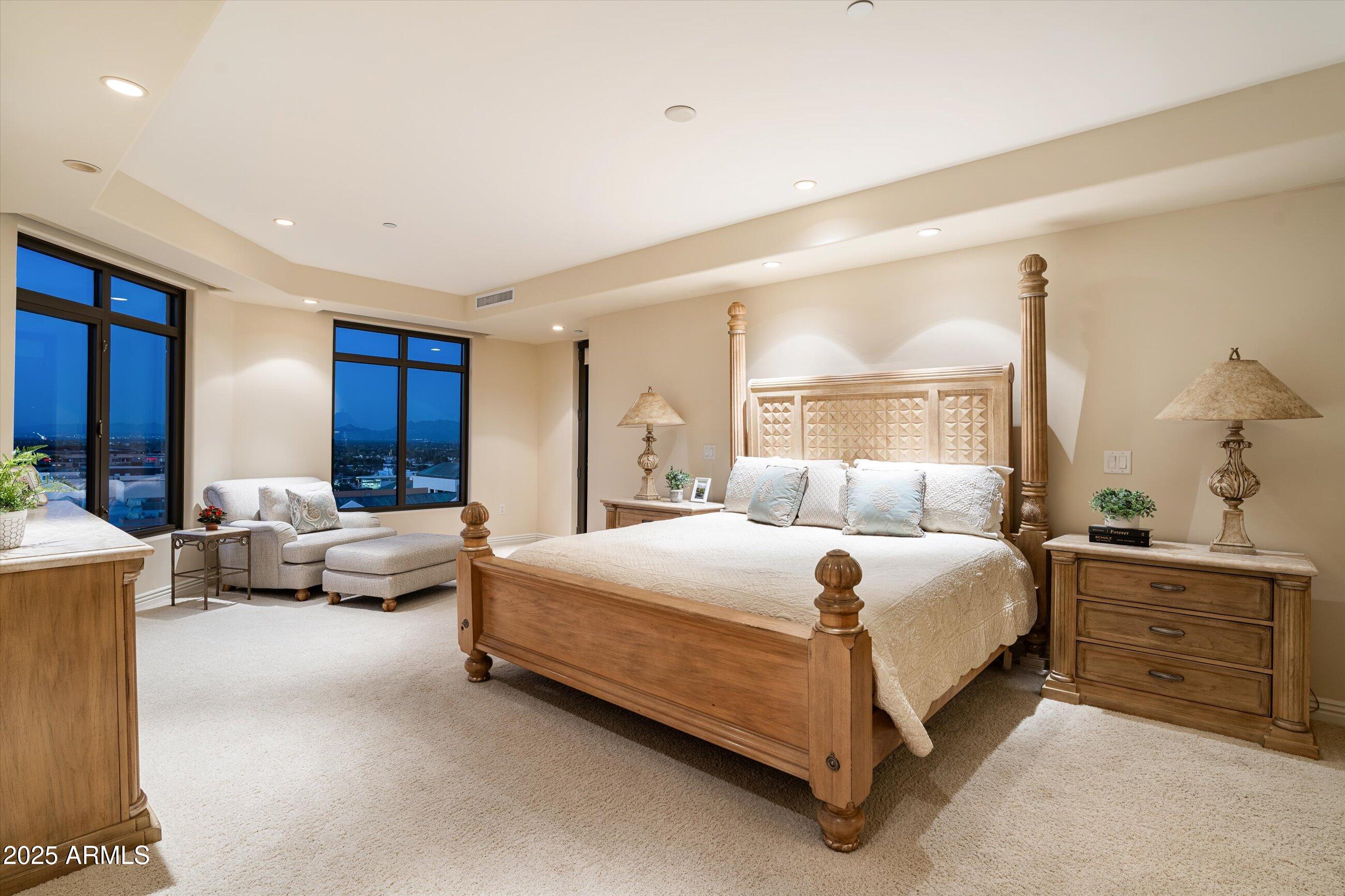 7181 East Camelback Road, Unit 1202 Scottsdale, AZ 85251 - Photo 20 of 47 a bedroom with a bed and a couch