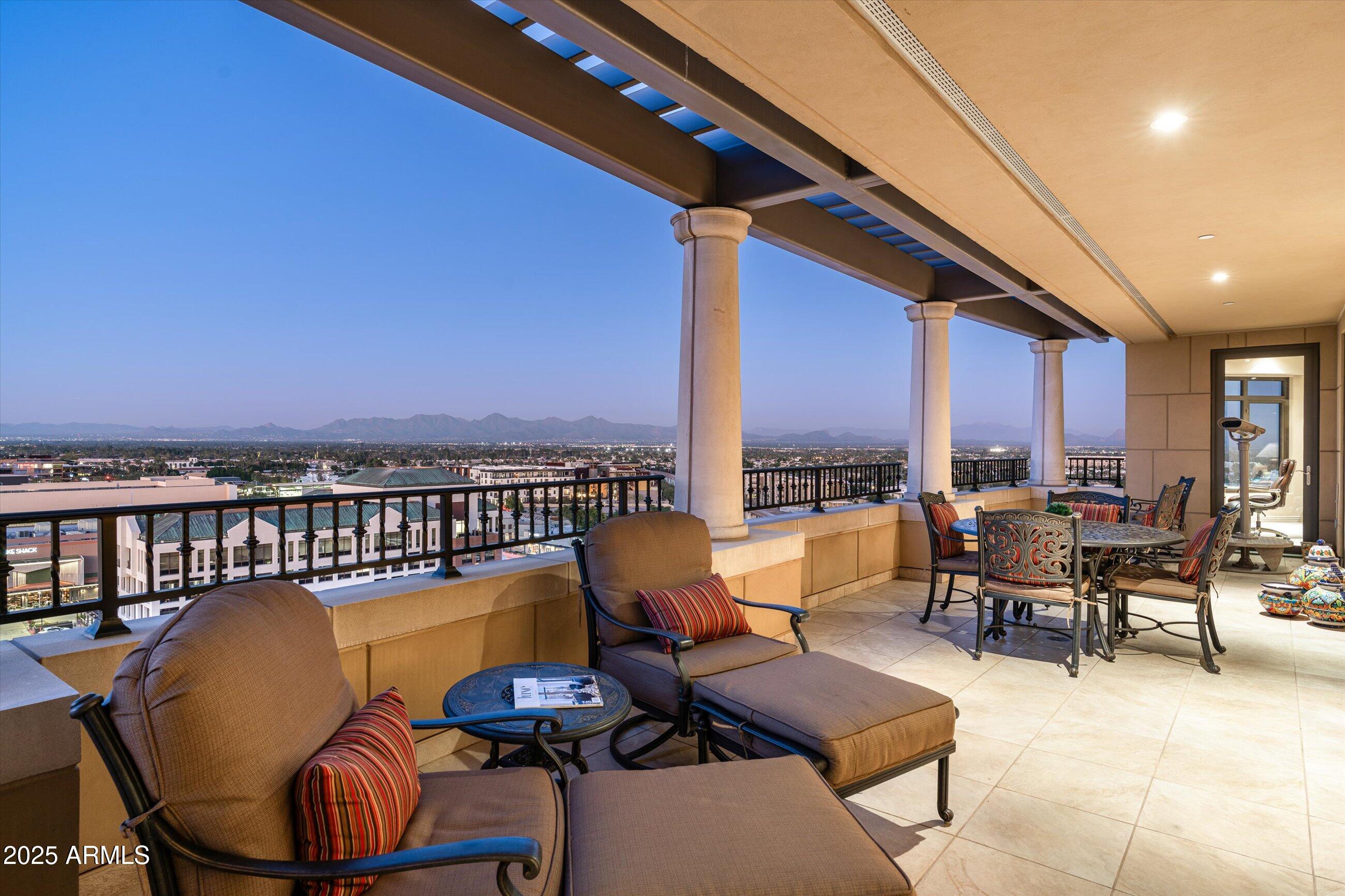 7181 East Camelback Road, Unit 1202 Scottsdale, AZ 85251 - Photo 2 of 47 a living room with furniture a rug and a floor to ceiling window