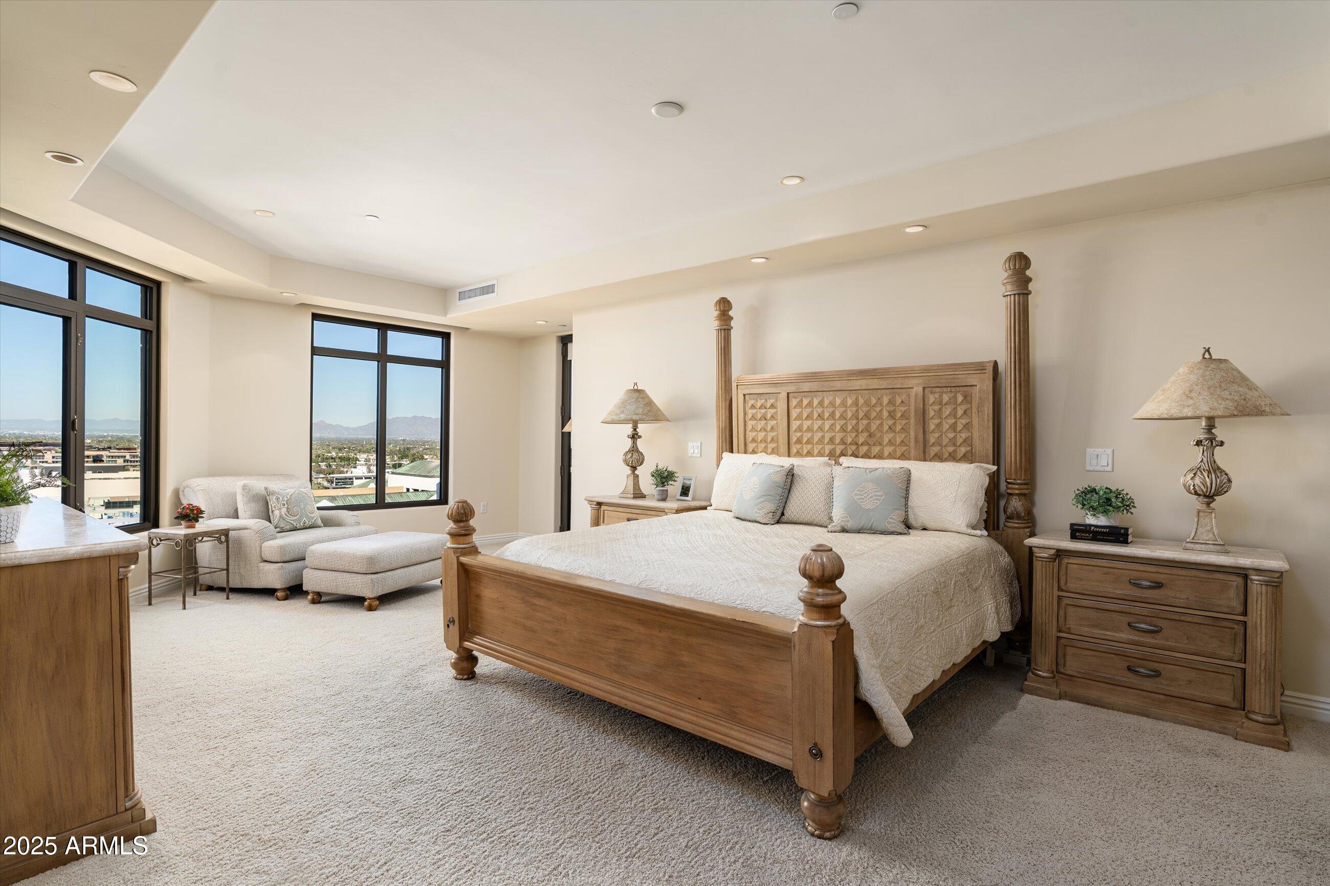 7181 East Camelback Road, Unit 1202 Scottsdale, AZ 85251 - Photo 21 of 47 a spacious bedroom with a bed and large windows