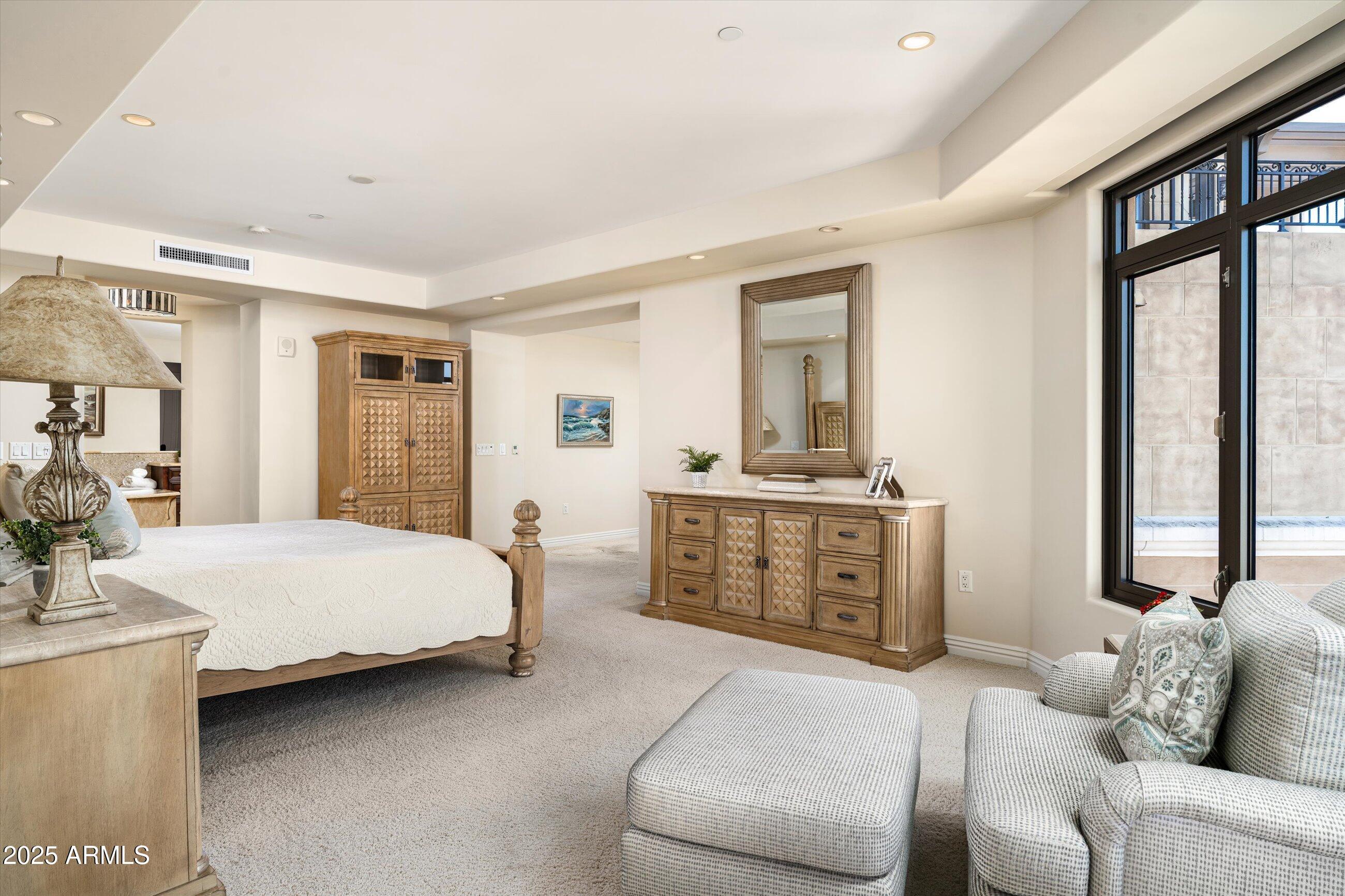 7181 East Camelback Road, Unit 1202 Scottsdale, AZ 85251 - Photo 22 of 47 a bedroom with furniture and a large window