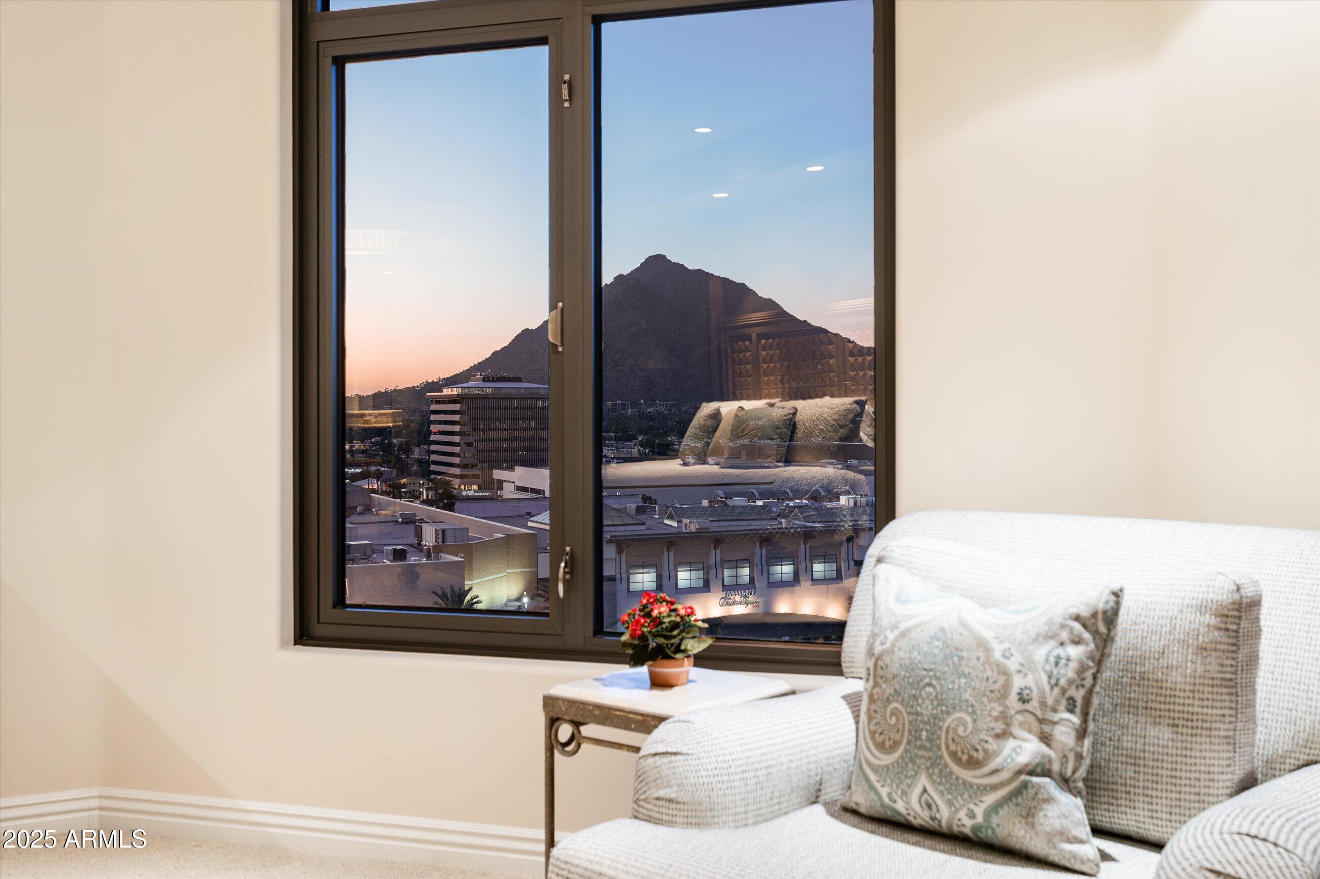 7181 East Camelback Road, Unit 1202 Scottsdale, AZ 85251 - Photo 23 of 47 a living room with furniture and a fireplace