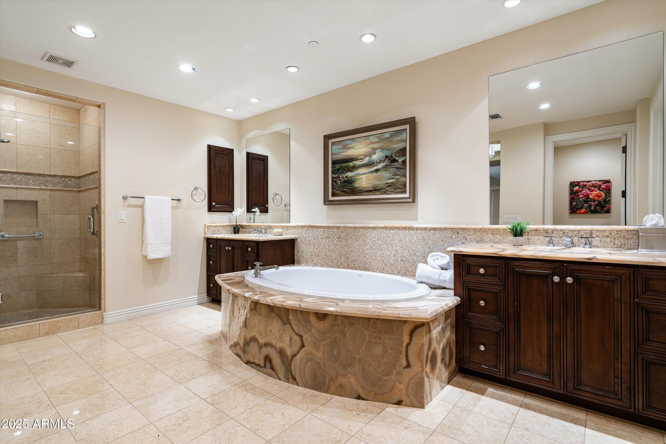 7181 East Camelback Road, Unit 1202 Scottsdale, AZ 85251 - Photo 28 of 47 a bathroom with a sink a toilet and shower