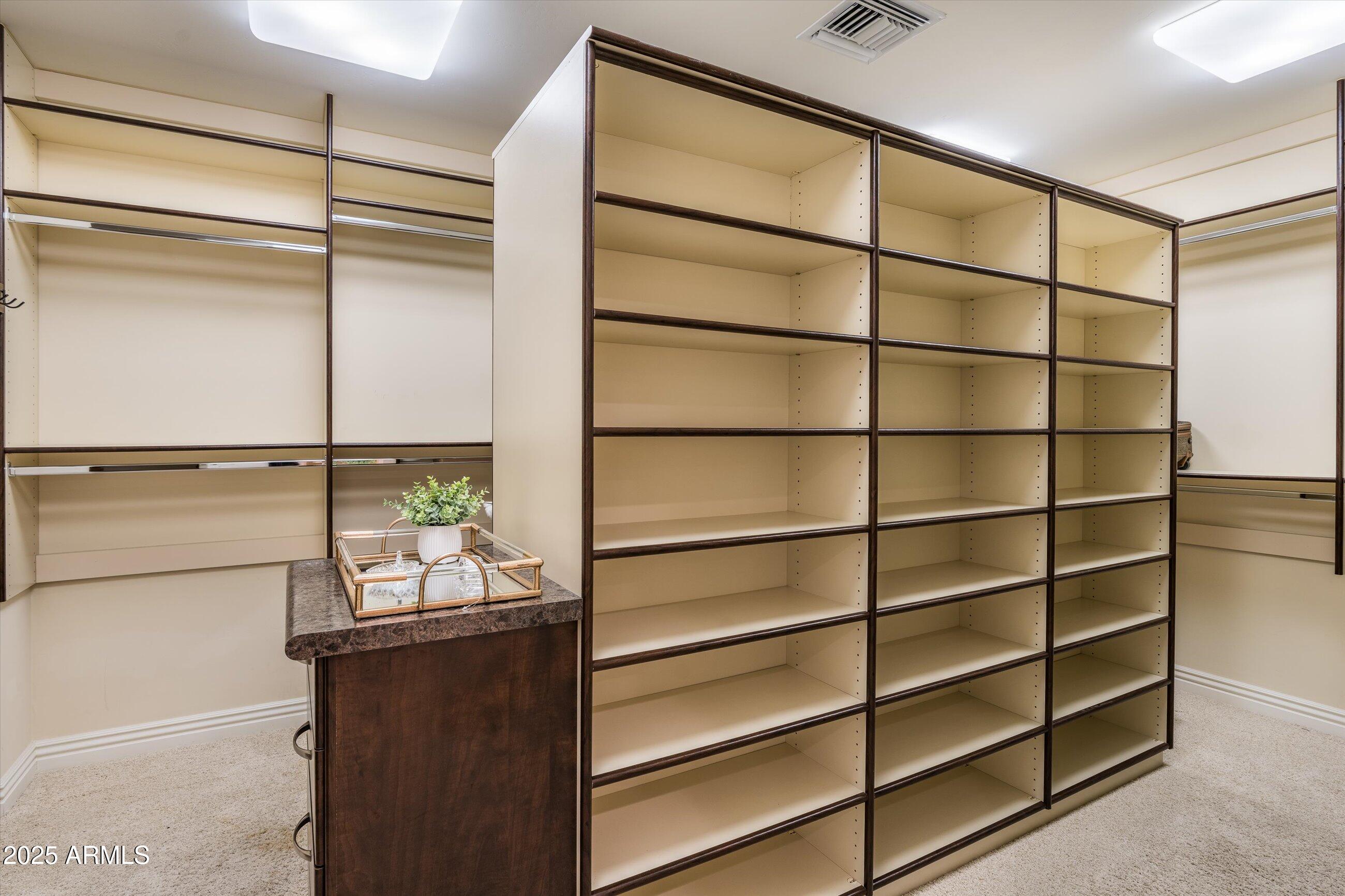 7181 East Camelback Road, Unit 1202 Scottsdale, AZ 85251 - Photo 30 of 47 a view of a room with racks on the wall and a window