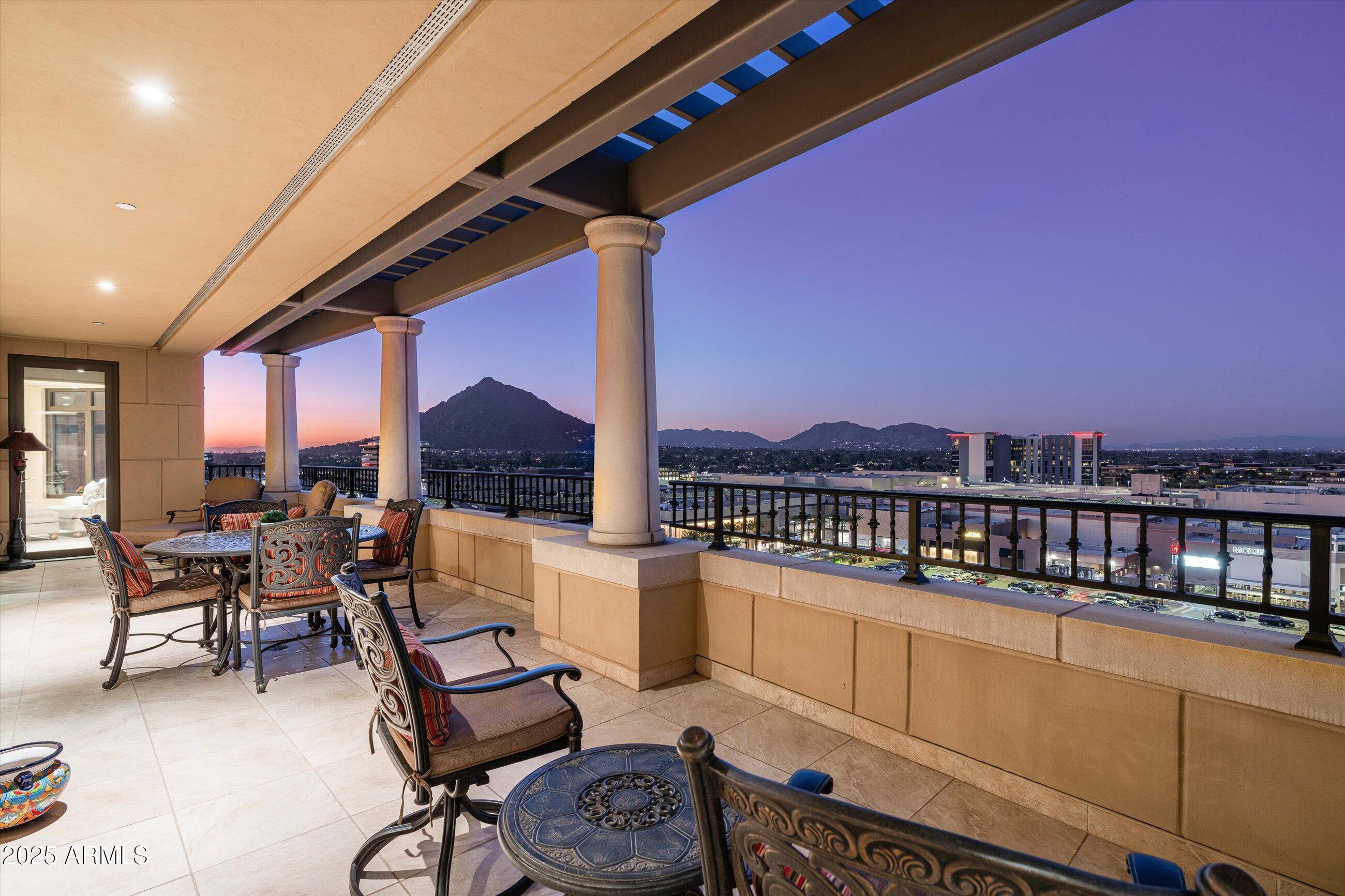 7181 East Camelback Road, Unit 1202 Scottsdale, AZ 85251 - Photo 3 of 47 a roof deck with table and chairs