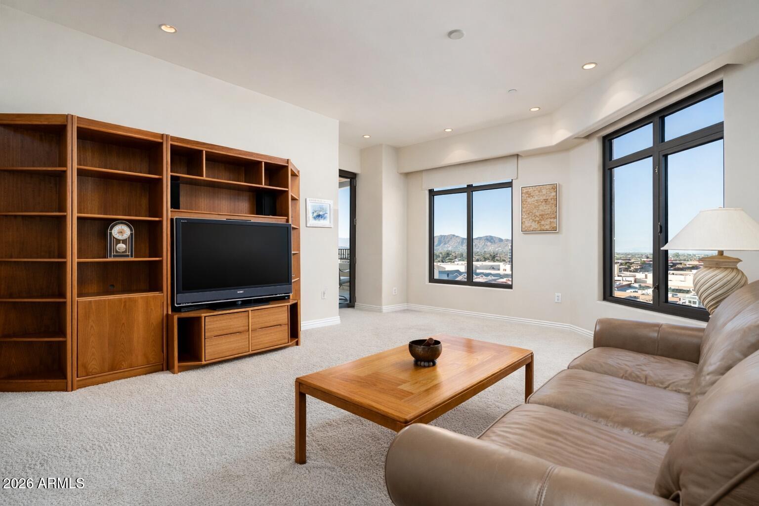 7181 East Camelback Road, Unit 1202 Scottsdale, AZ 85251 - Photo 31 of 47 a living room with furniture and a flat screen tv