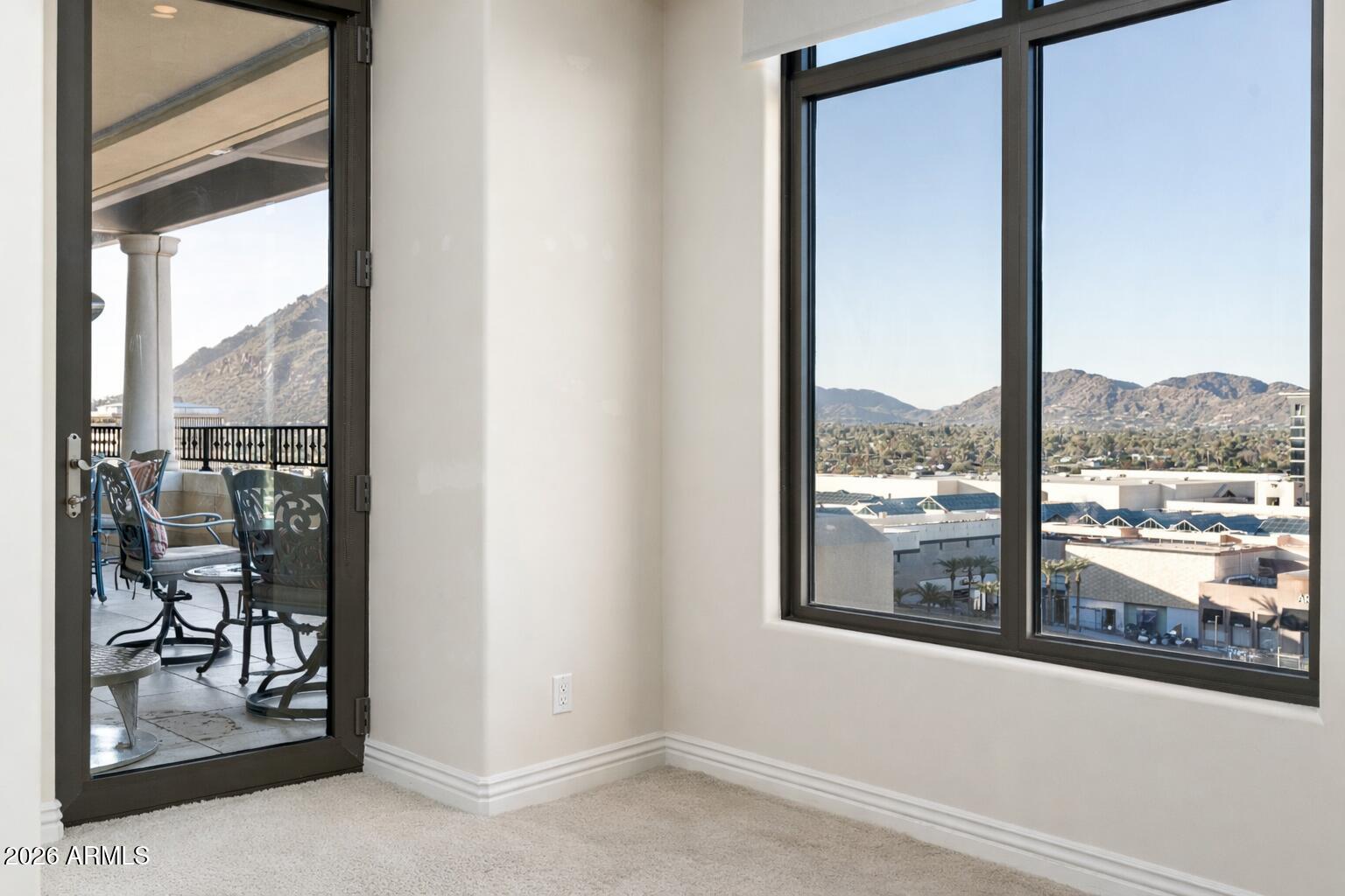 7181 East Camelback Road, Unit 1202 Scottsdale, AZ 85251 - Photo 32 of 47 an empty room with wooden floor and windows