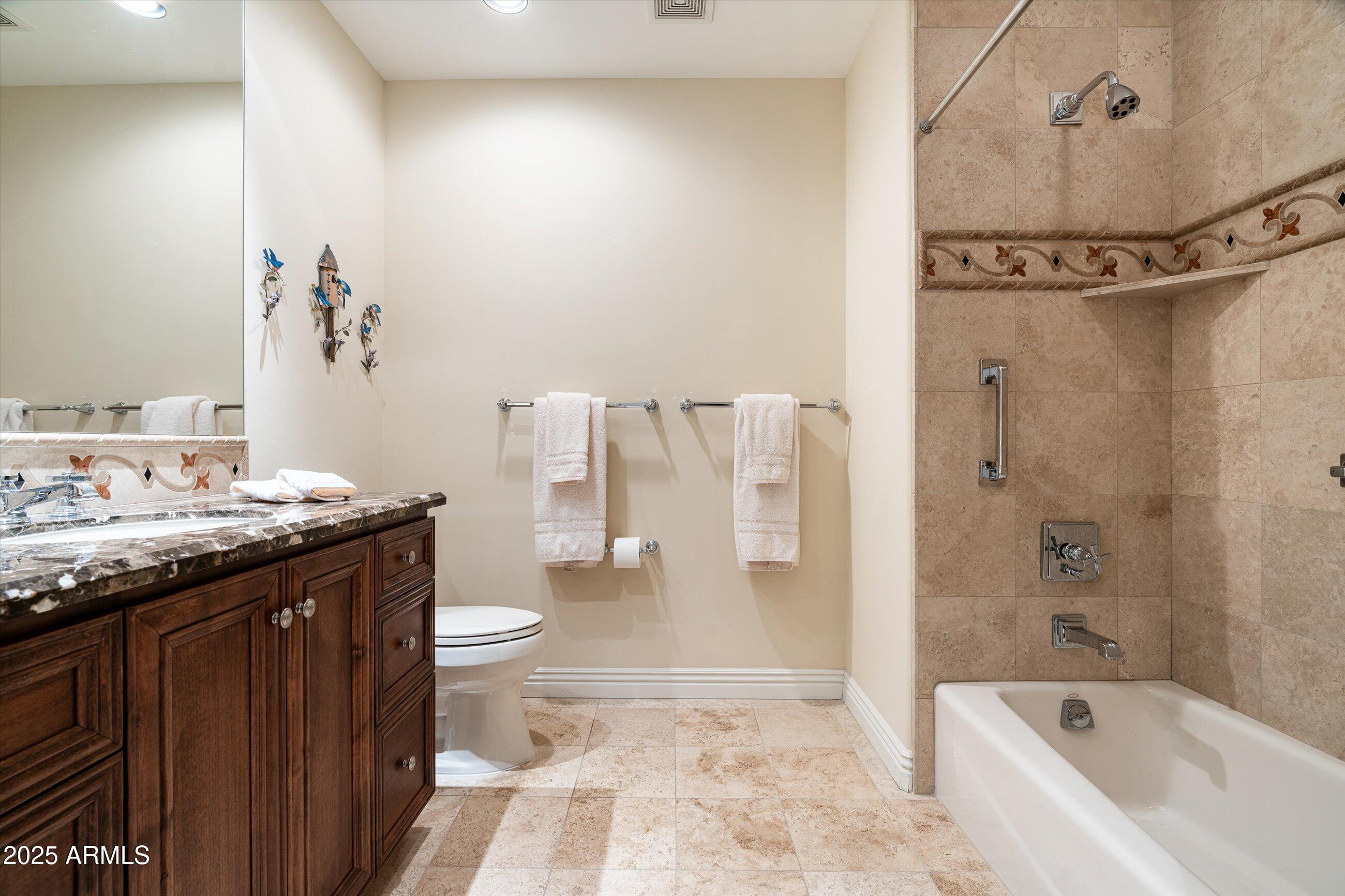 7181 East Camelback Road, Unit 1202 Scottsdale, AZ 85251 - Photo 33 of 47 a bathroom with a granite countertop sink a toilet and shower