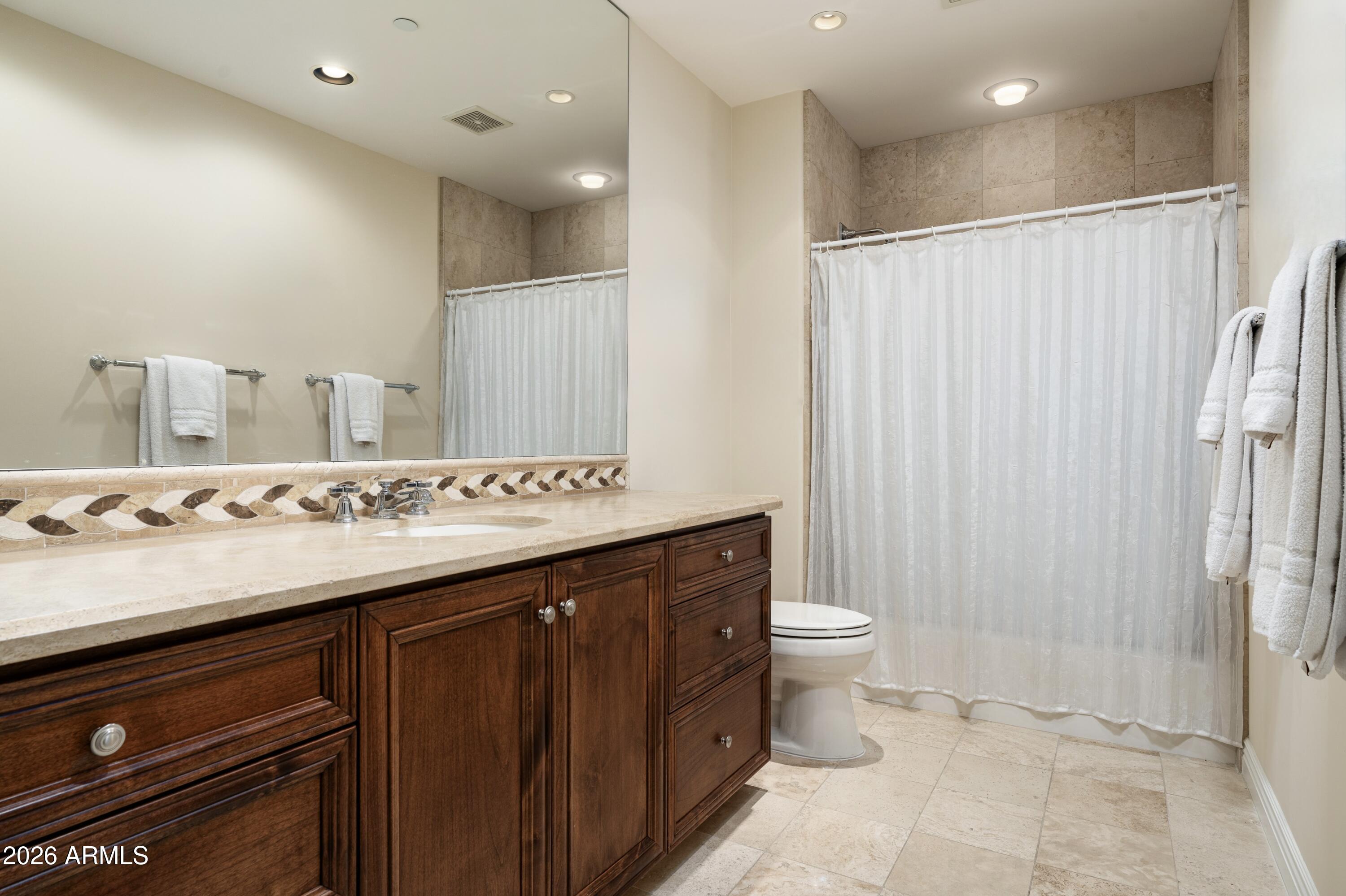 7181 East Camelback Road, Unit 1202 Scottsdale, AZ 85251 - Photo 35 of 47 a bathroom with a sink and a mirror