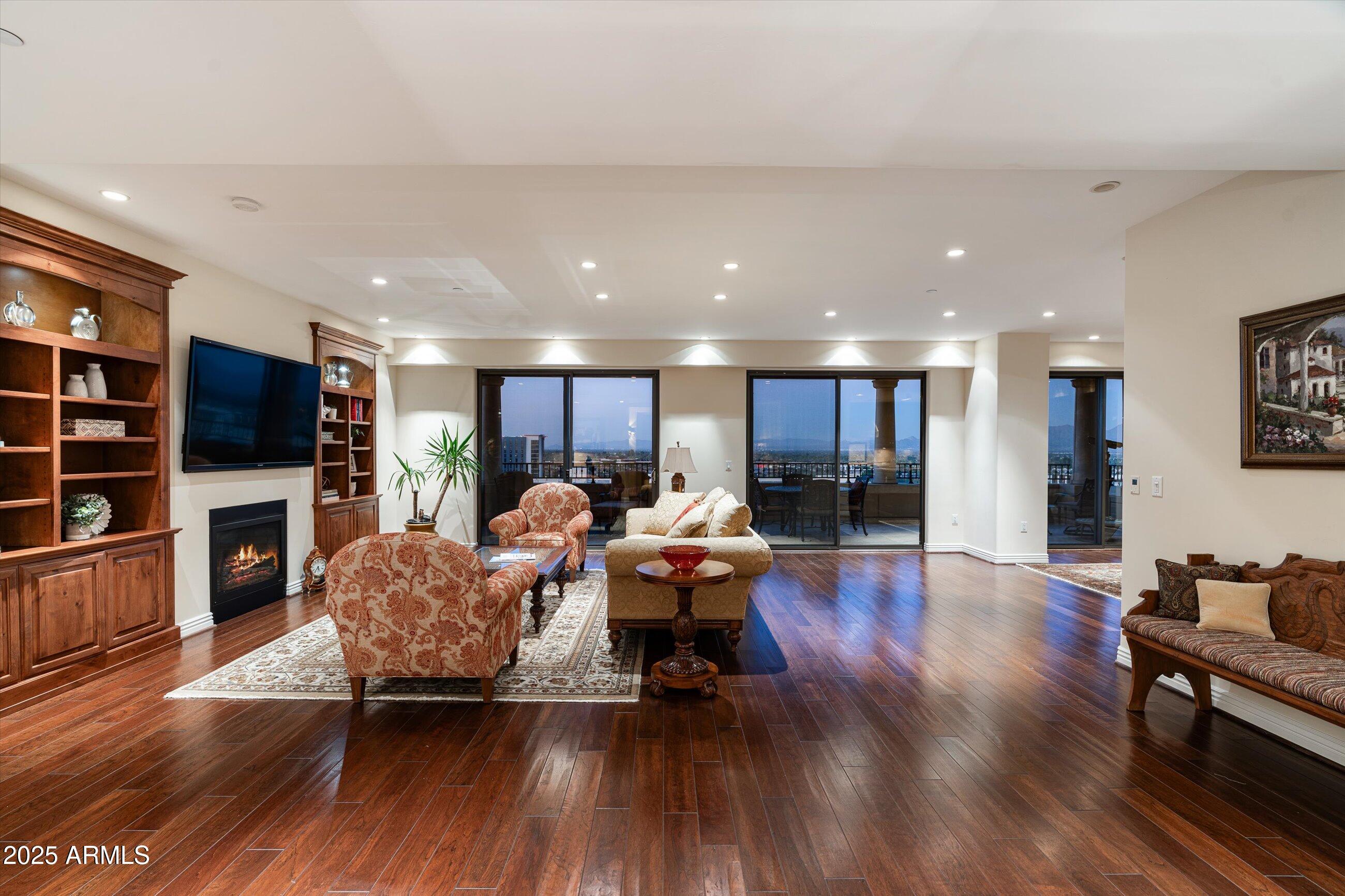 7181 East Camelback Road, Unit 1202 Scottsdale, AZ 85251 - Photo 4 of 47 a living room with furniture wooden floor and a kitchen view