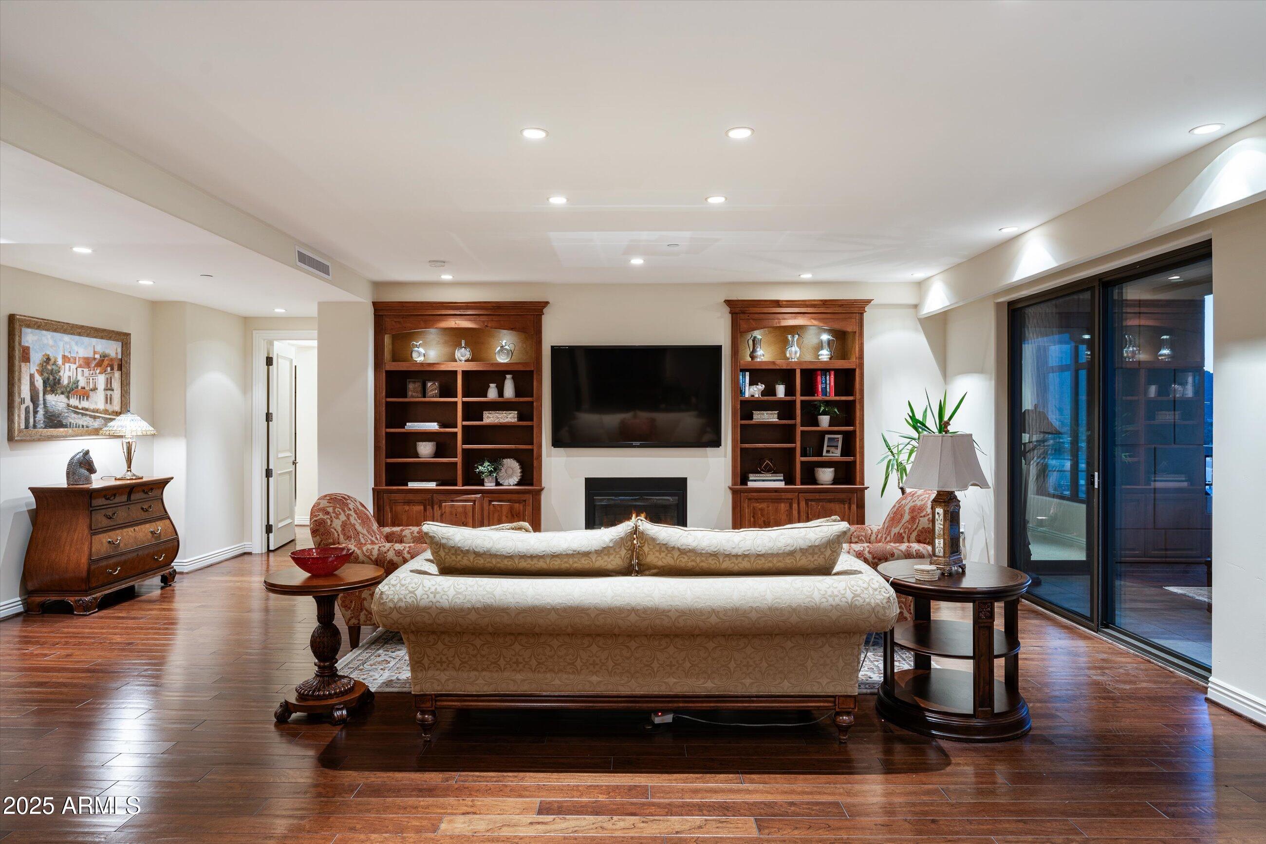 7181 East Camelback Road, Unit 1202 Scottsdale, AZ 85251 - Photo 6 of 47 a living room with fireplace furniture and a flat screen tv