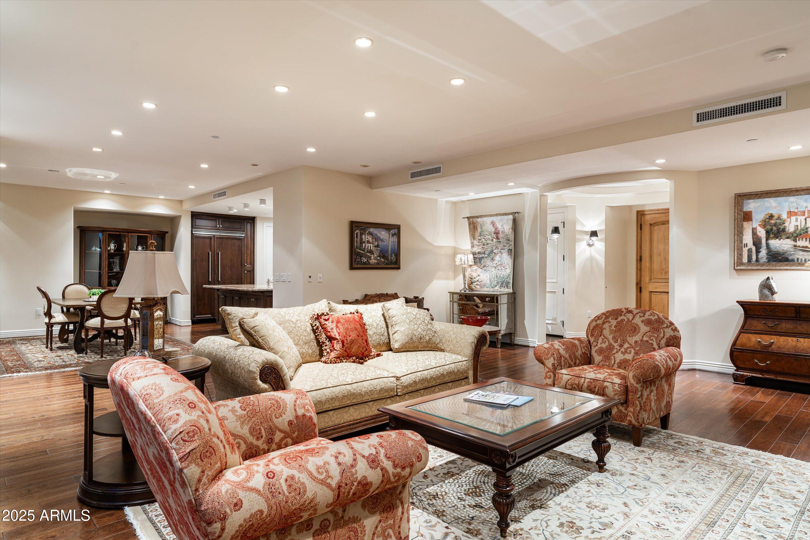7181 East Camelback Road, Unit 1202 Scottsdale, AZ 85251 - Photo 8 of 47 a living room with furniture a table and a potted plant