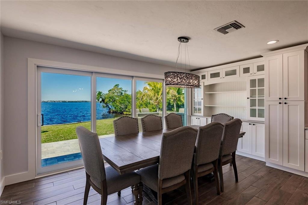 138 Riverview Road Fort Myers, FL 33905 - Photo 20 of 50 Dining room with a water view, dark wood finished floors, visible vents, and recessed lighting