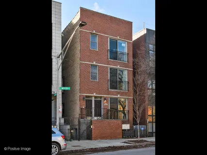 a front view of a building with parking space