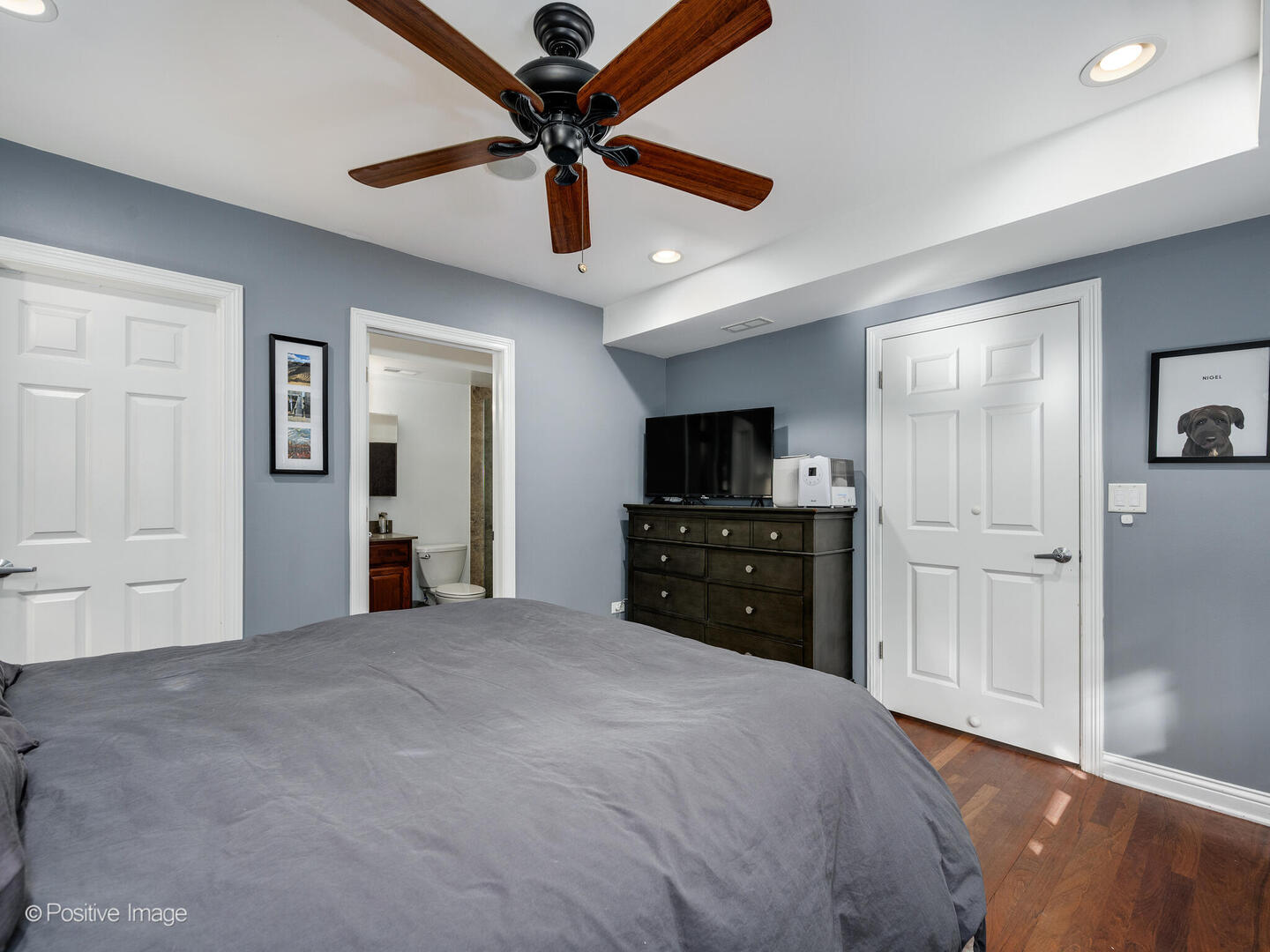 1440 North Wood Street, Unit 1R Chicago, IL 60622 - Photo 16 of 22 a large bedroom with a bed and a flat tv screen on wall