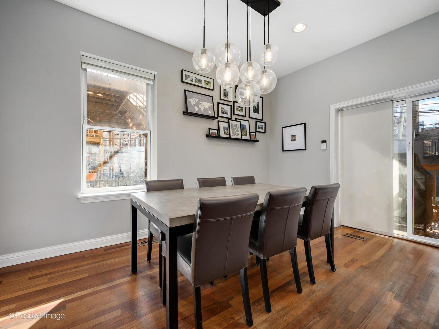 1440 North Wood Street, Unit 1R Chicago, IL 60622 - Photo 6 of 22 a view of a dining room with furniture a chandelier and wooden floor