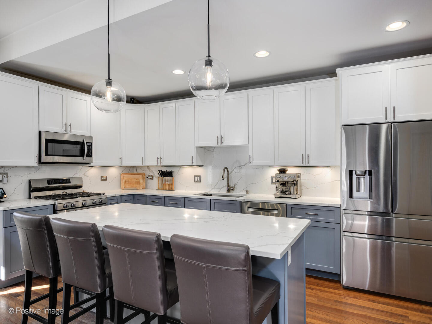 1440 North Wood Street, Unit 1R Chicago, IL 60622 - Photo 7 of 22 a kitchen with stainless steel appliances granite countertop a refrigerator a stove a sink a center island a dining table and chairs with wooden floor