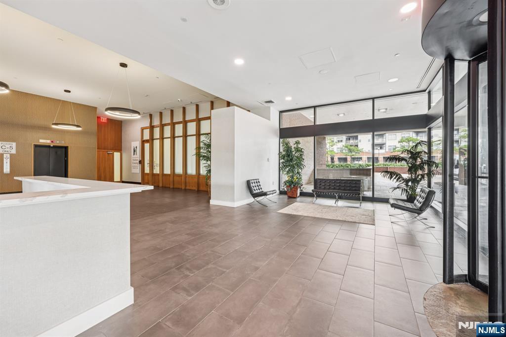 2 Executive Drive, Unit 809 Fort Lee, NJ 07024 - Photo 2 of 11 a view of an entryway with a floor to ceiling window and a living room