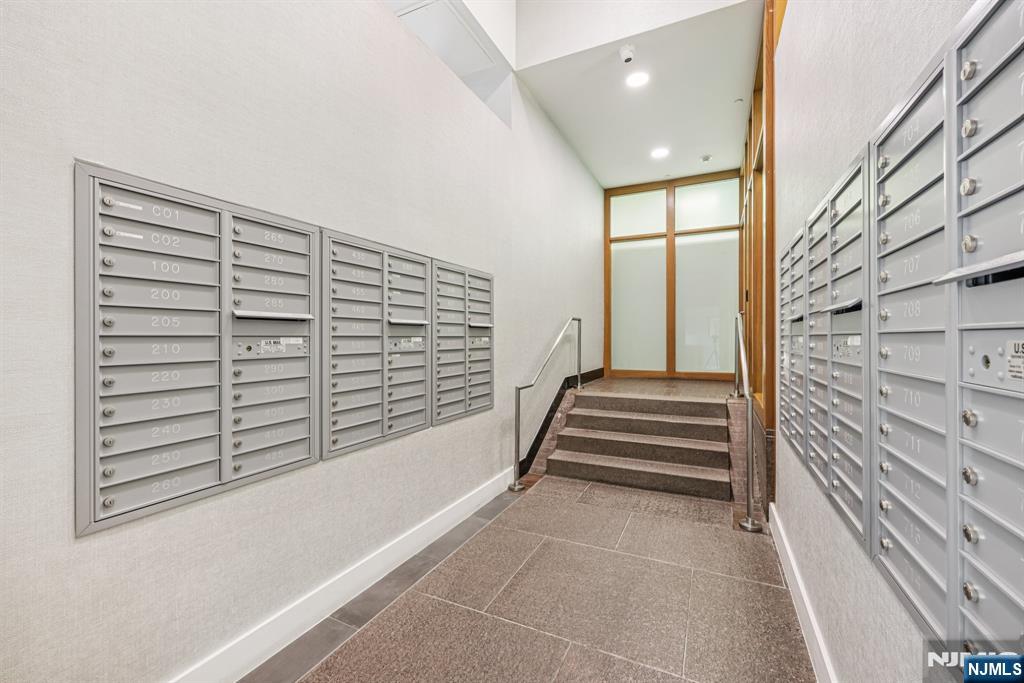 2 Executive Drive, Unit 809 Fort Lee, NJ 07024 - Photo 4 of 11 a view of entryway with stairs and wooden floor