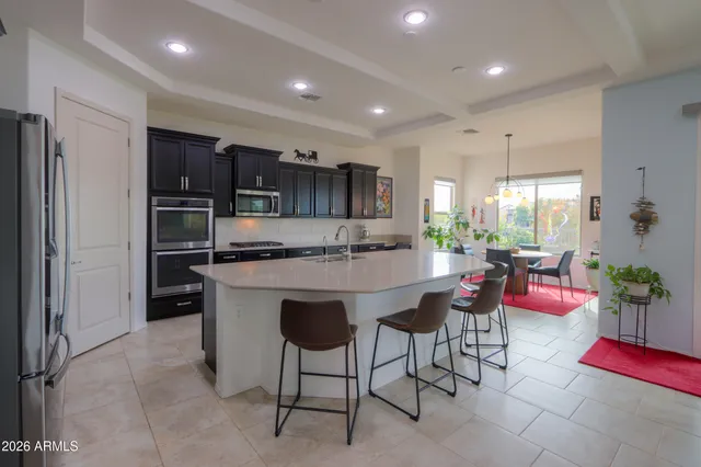 a kitchen with a table chairs refrigerator and couch