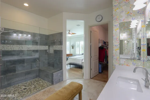 an aerial view of a residential houses with outdoor space and trees