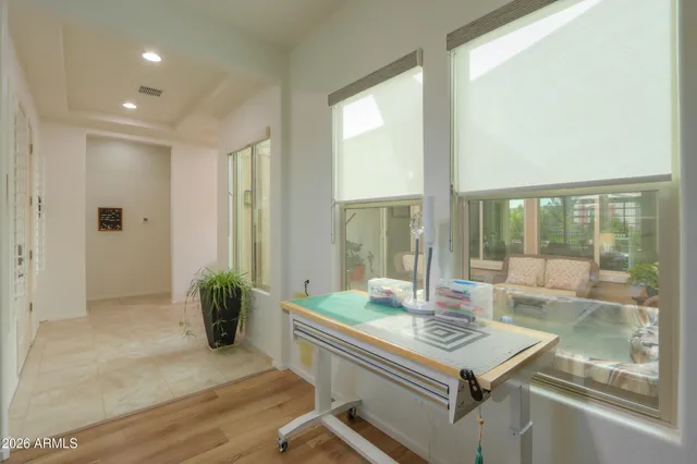 a living room with furniture a rug and a large window