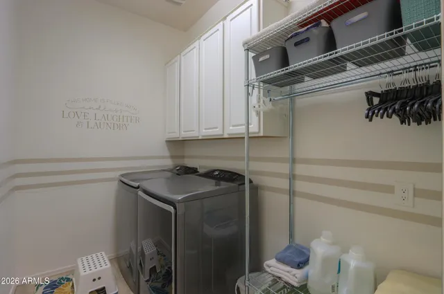 a living room with furniture a table and chairs