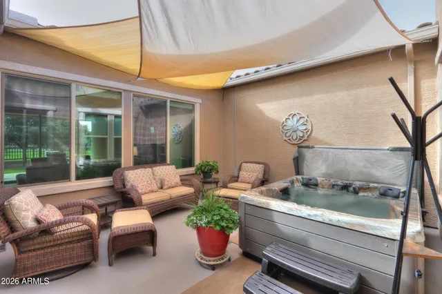 a living room with furniture and a floor to ceiling window