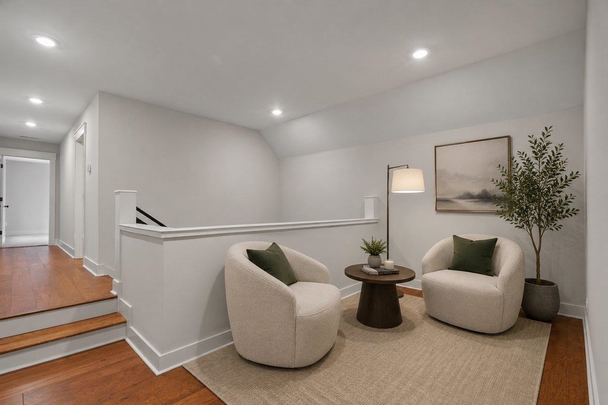 240 Burrows Road Collierville, TN 38017 - Photo 33 of 37 Upper-level landing featuring hardwood flooring, recessed lighting, white wall paneling, and a stairway with dark handrails