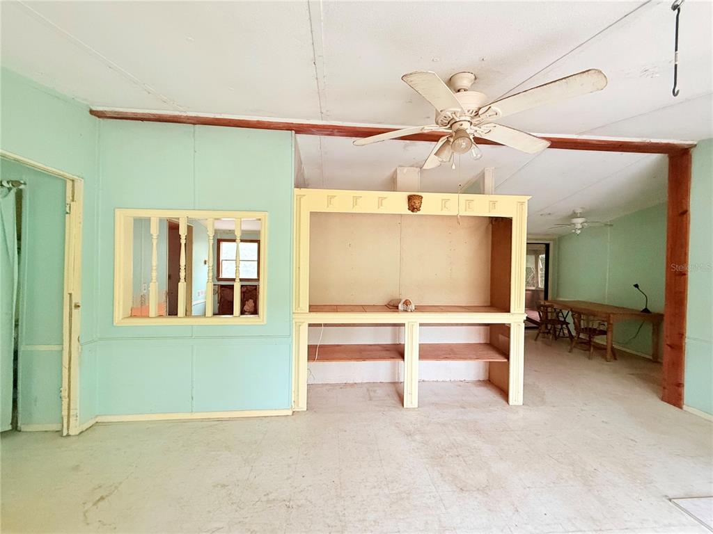 7324 Northwest 152nd Place Alachua, FL 32615 - Photo 35 of 44 an empty room with ceiling fan and windows