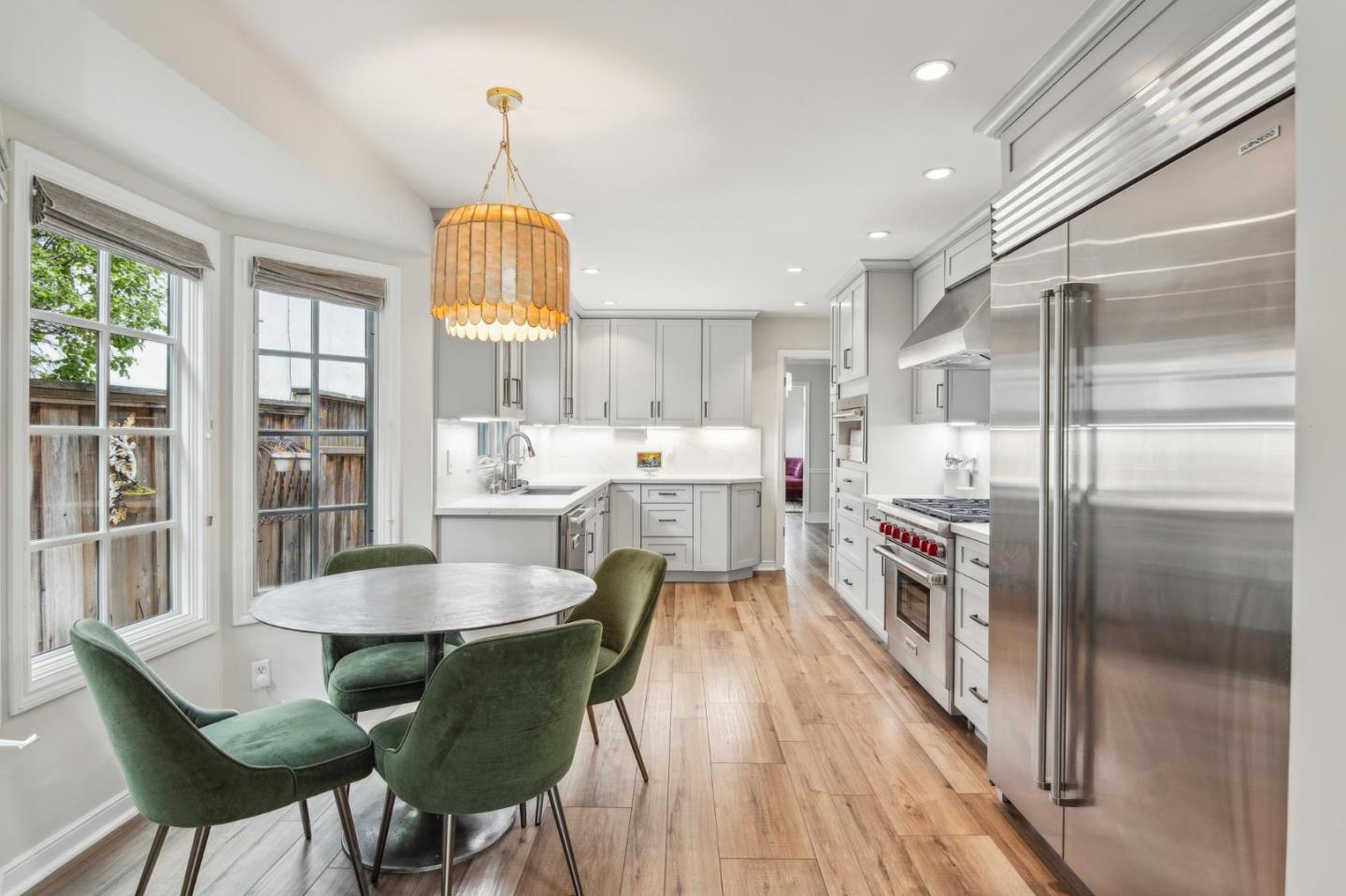 731 Oregon Avenue San Mateo, CA 94402 - Photo 6 of 34 a kitchen with stainless steel appliances a dining table chairs refrigerator and sink