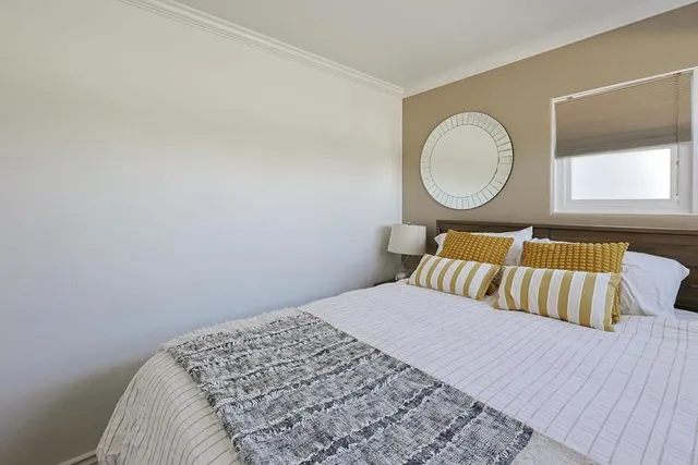 a bedroom with a bed and a window