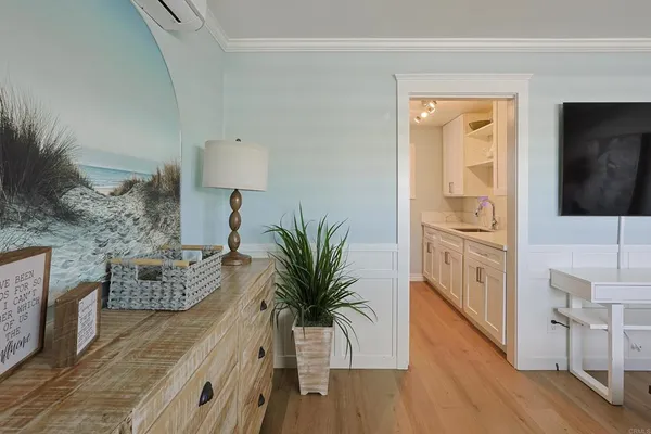 a hallway with furniture and wooden floor