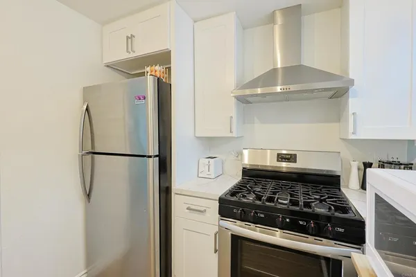 a kitchen with a stove and a refrigerator