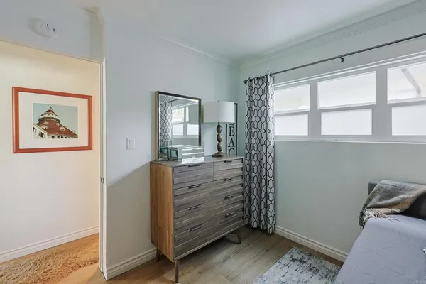 a view of room with window and wooden floor