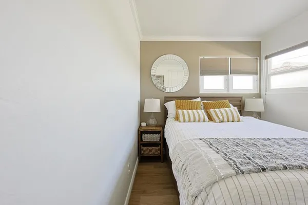 a bed sitting in a bedroom next to a window