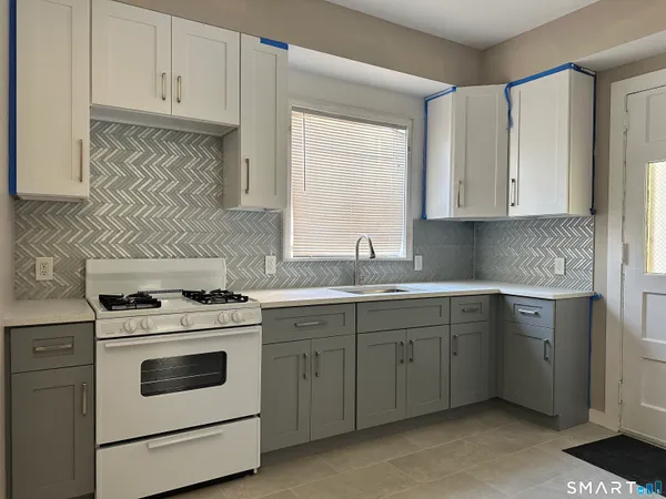 a kitchen with a stove a sink and a refrigerator