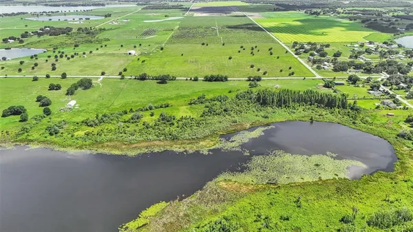 a view of a green field with an ocean