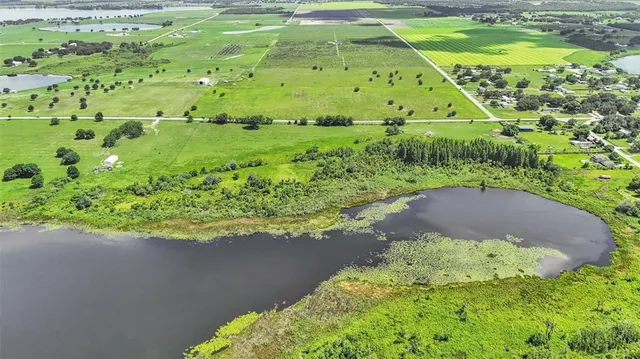a view of a green field with an ocean