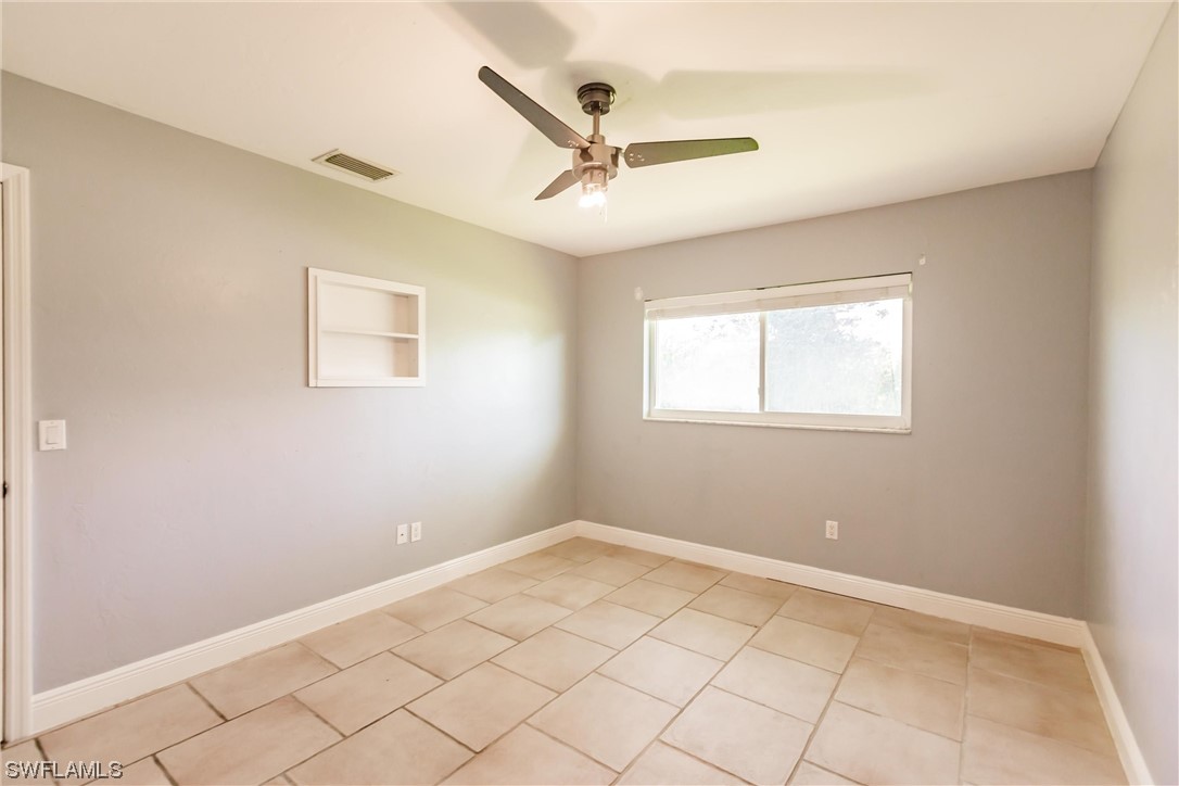 72 Pebble Beach Boulevard Naples, FL 34113 - Photo 13 of 15 a view of a livingroom with a ceiling fan and window
