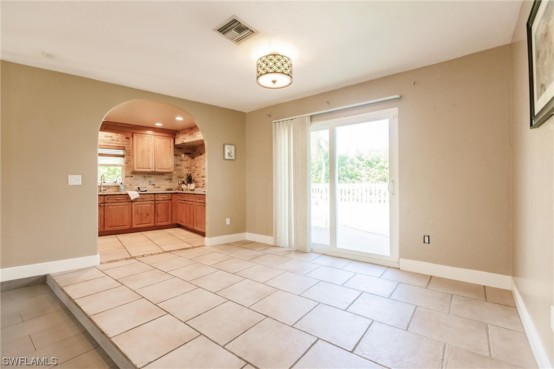 72 Pebble Beach Boulevard Naples, FL 34113 - Photo 5 of 15 a view of a kitchen with kitchen furniture and a window