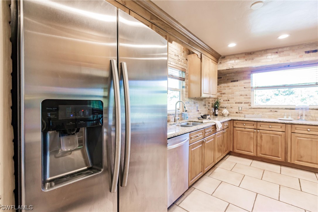 72 Pebble Beach Boulevard Naples, FL 34113 - Photo 7 of 15 a kitchen with stainless steel appliances granite countertop a refrigerator and a sink