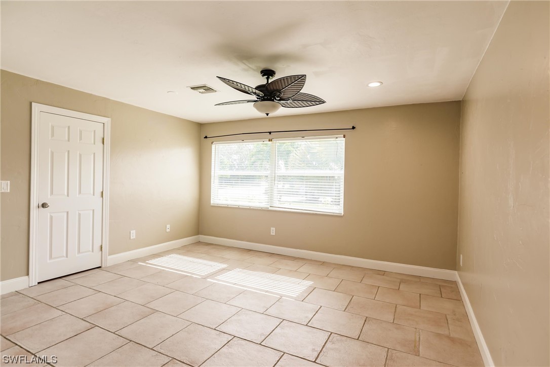 72 Pebble Beach Boulevard Naples, FL 34113 - Photo 9 of 15 a view of an empty room with a window