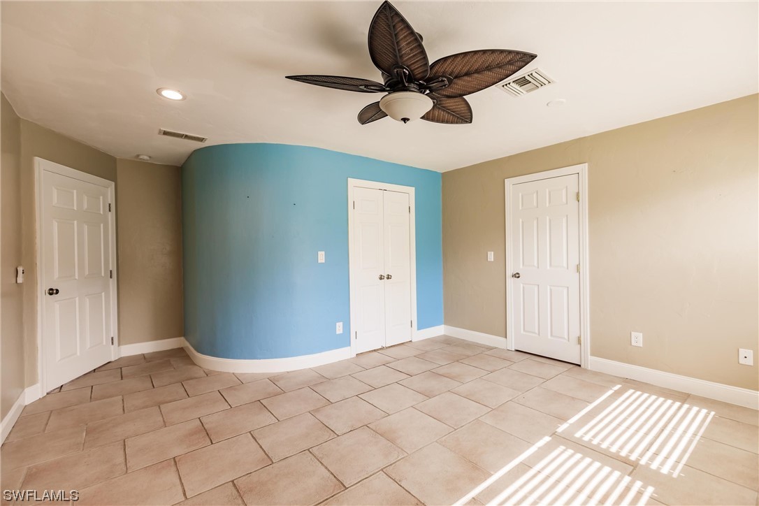 72 Pebble Beach Boulevard Naples, FL 34113 - Photo 10 of 15 a view of a livingroom with a ceiling fan and window