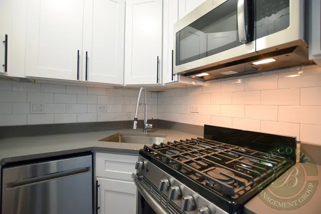 a stove top oven sitting inside of a kitchen