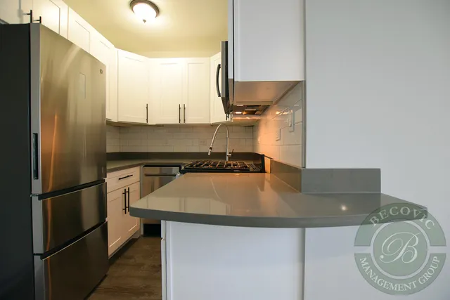 a kitchen with kitchen island a appliances a sink and a refrigerator