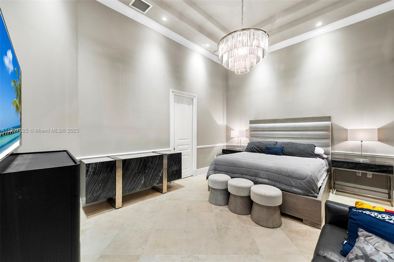 3914 Island Estates Drive Aventura, FL 33160 - Photo 26 of 40 a spacious bedroom with a bed and a chandelier