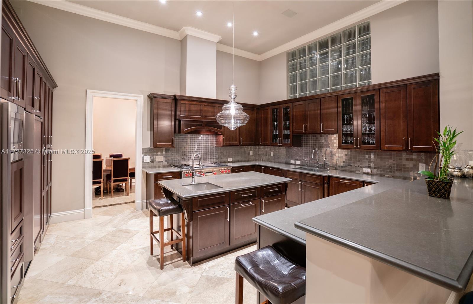 3914 Island Estates Drive Aventura, FL 33160 - Photo 32 of 40 a kitchen with a sink a counter and cabinets
